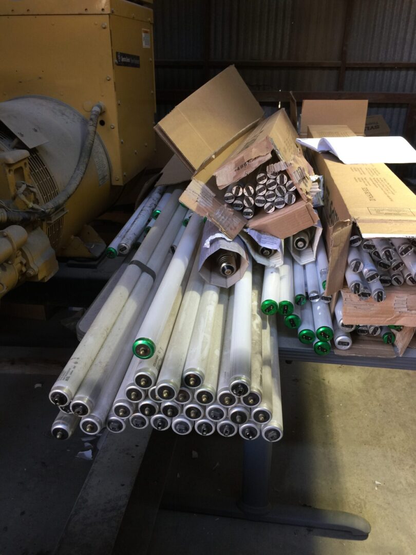 A pile of pipes and boxes in a warehouse.