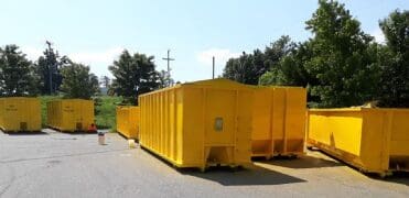 A row of yellow dumpsters