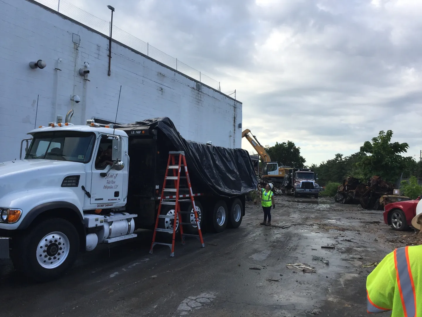 Truck and workers cleaning up debris.
