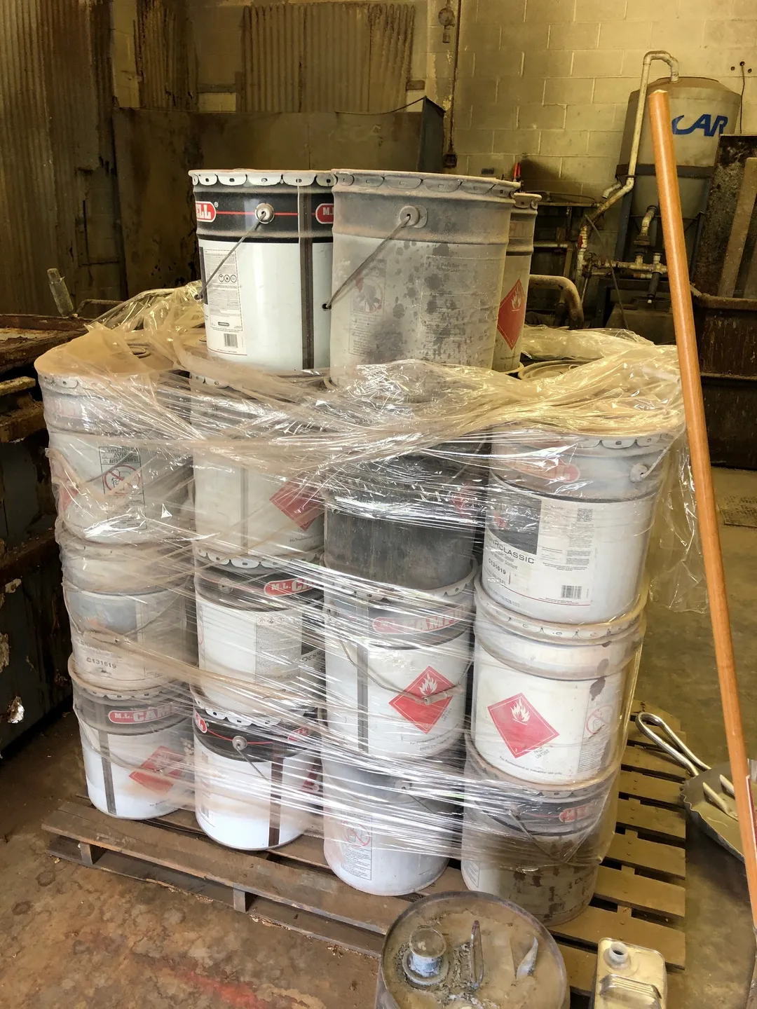 A stack of paint buckets wrapped in plastic.